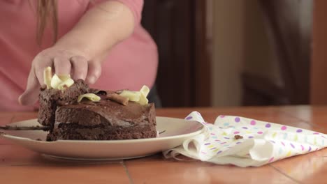 Woman-serving-piece-of-chocolate-cake-wide-shot