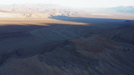 Drone-flying-forward-over-a-beautiful-valley-in-Devil's-Middle-Basin-located-in-Death-Valley-National-Park-in-California