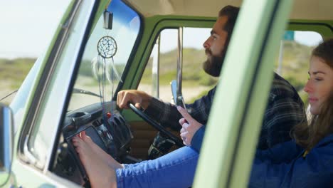 young couple discussing on mobile phone in van 4k