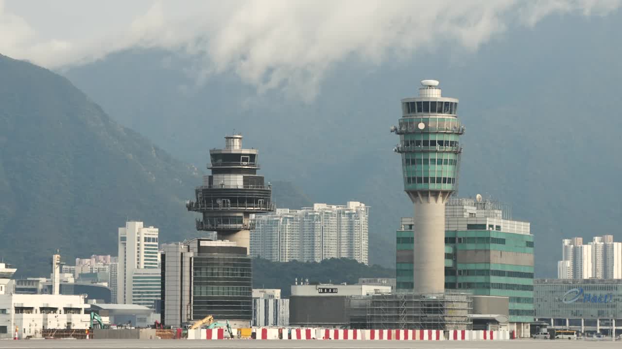 Time lapse of the control tower at HKIA airport with planes passing by