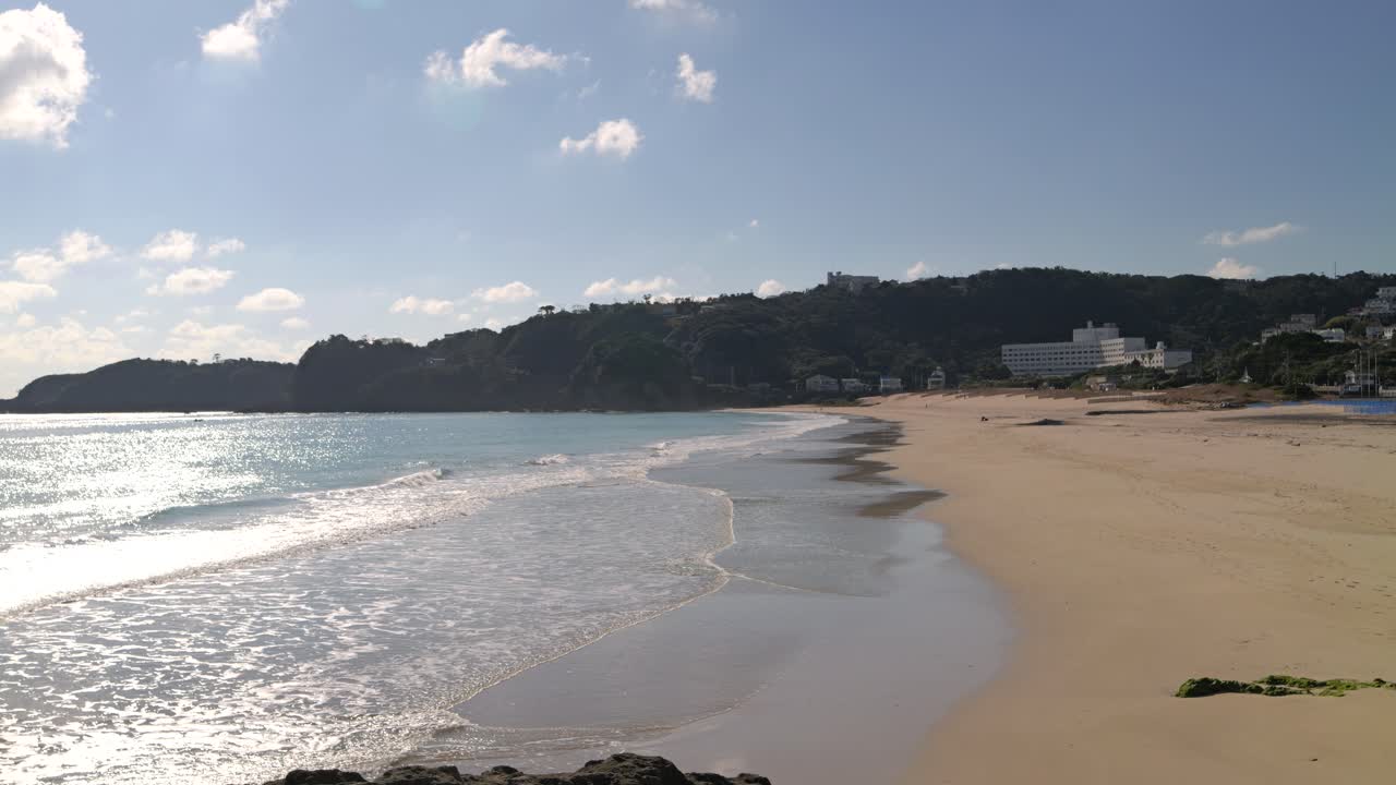 hermosa playa de arena abierta sin gente, olas en movimiento lento
