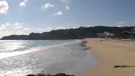 beautiful wide open sandy beach with no people, slow motion waves