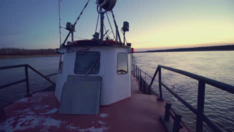 tugboat and barge on river at sunset