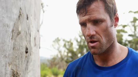 fit man pouring water after workout during obstacle course