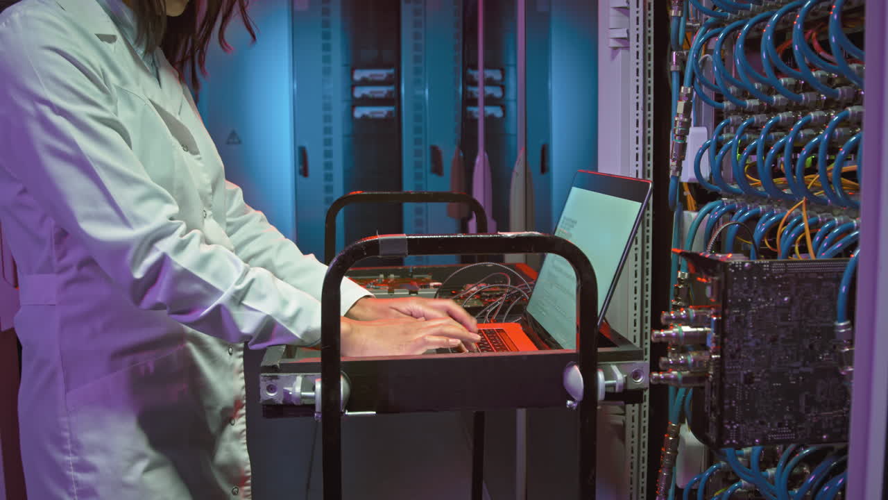 Female IT Specialist Working on Laptop in Data Center