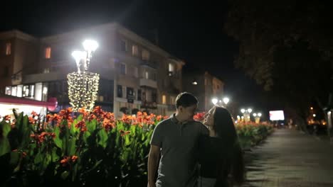 couple's romantic evening stroll on a lit street