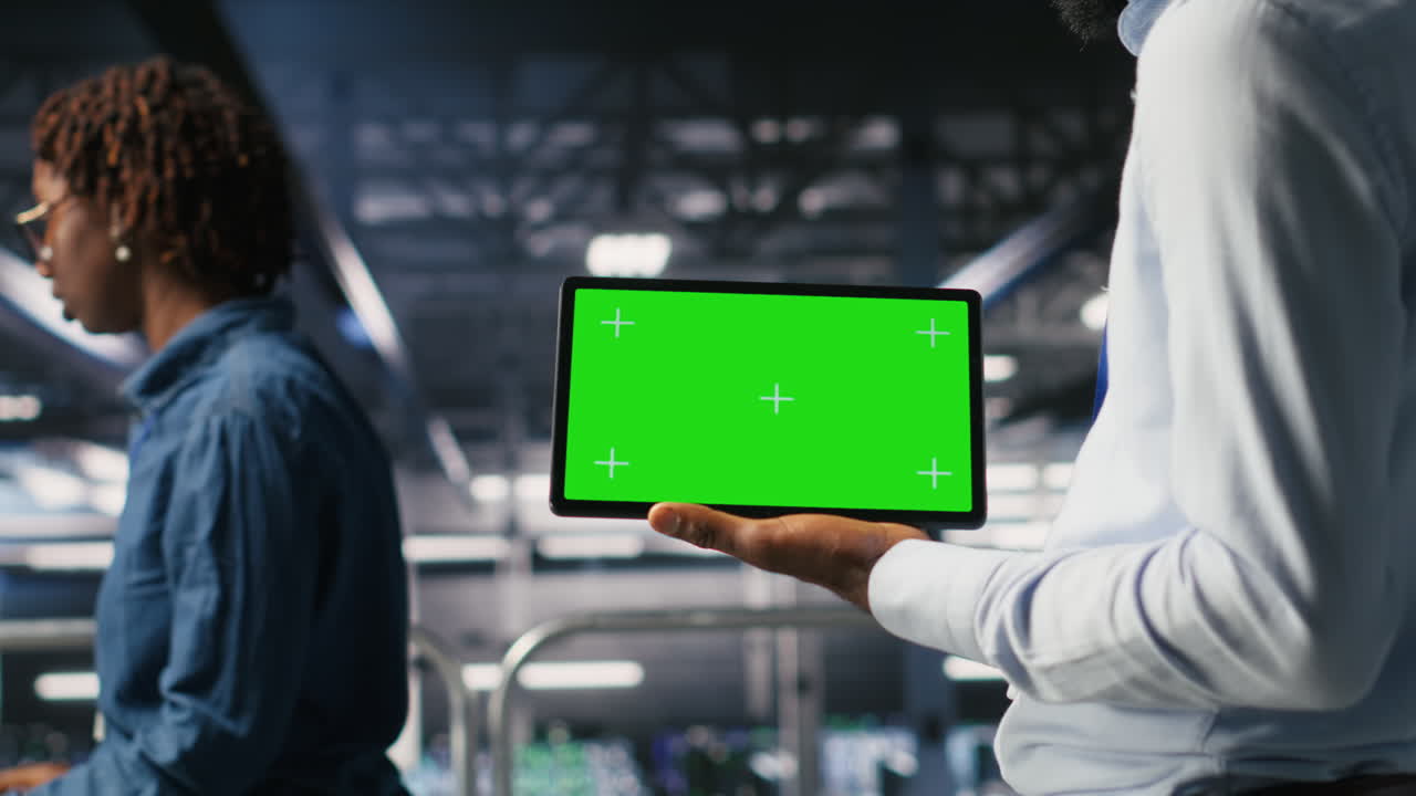 Close up of engineer using green screen mockup tablet in data center