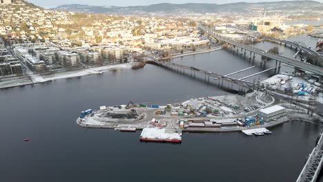 building of an artificial island in the riverbed of dramenselva, near the harbor in drammen, norway