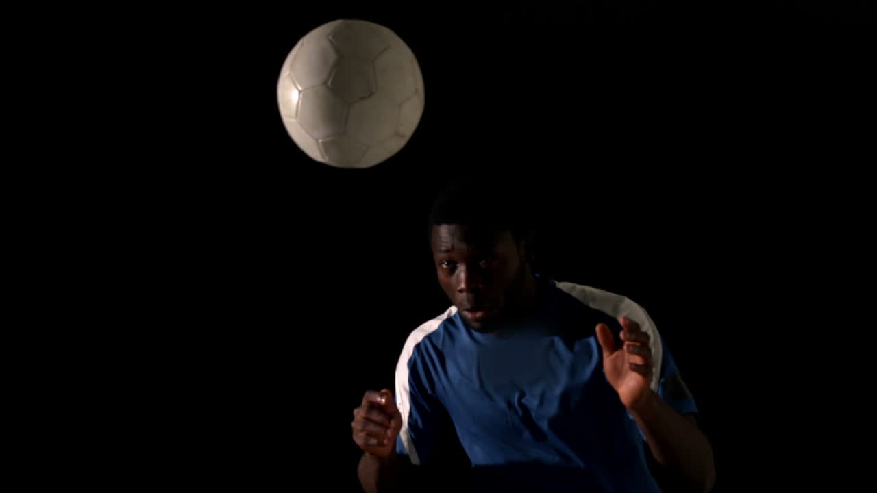 Football player heading the ball 