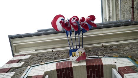 french building exterior with flags and sign