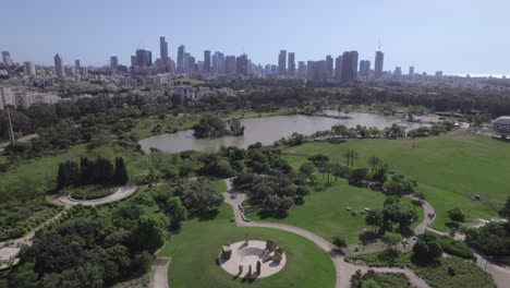 tilt down from tel aviv skyline to the stone garden in the yarkon park