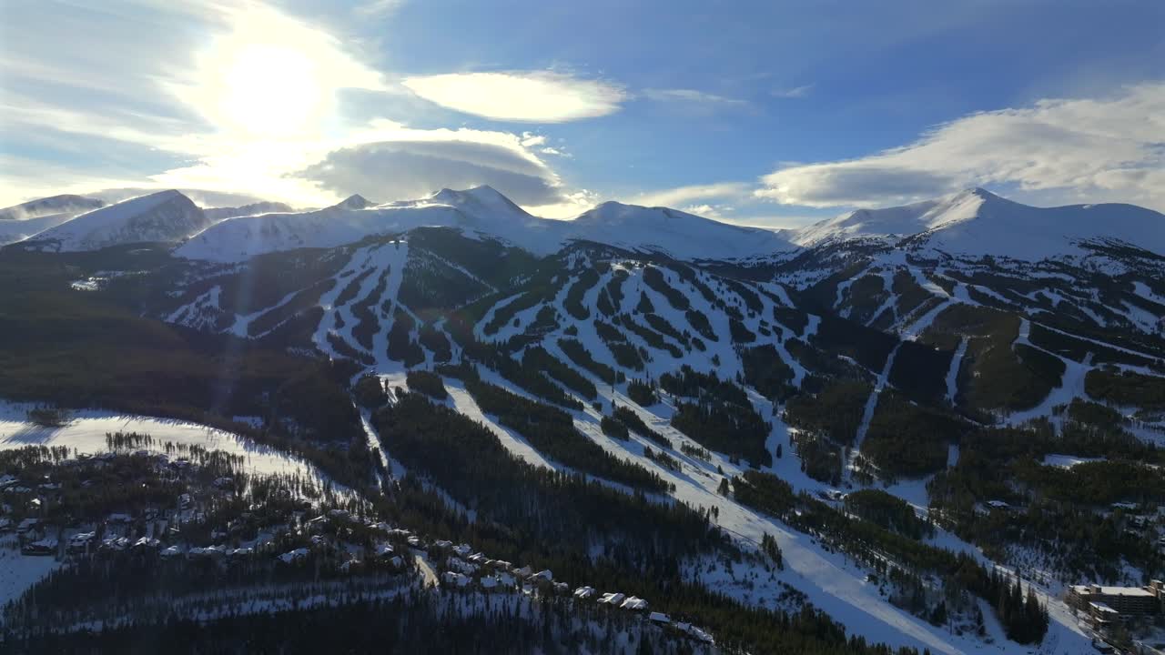 Breckenridge Ski Resort mountain town Colorado aerial drone sunset Winter December January skiing trails run Peak 9 10 Ten Mile Range Bald Mountain Epic Vail Pass cirrus clouds chairlifts down motion