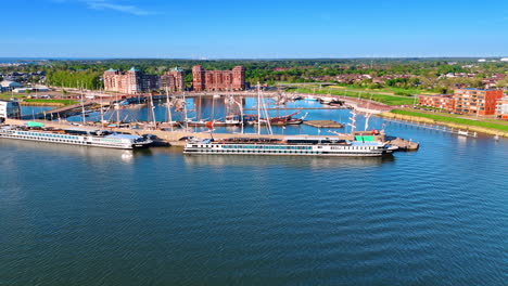 ships in the port of lelystad, the netherlands. aerial perspective on the beautiful green city on sunny day.