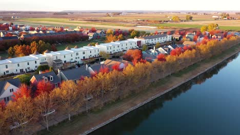 colorful fall trees in neighborhood suburbs sunset drone shot 4k