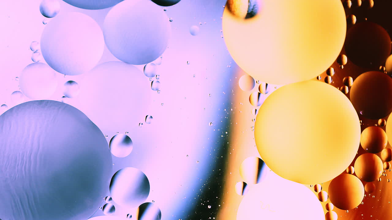 Real abstract colourful oil drops in water rotation with color gradient mixing background