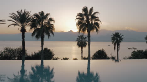 waterscape with swimming pool and sea at sunset