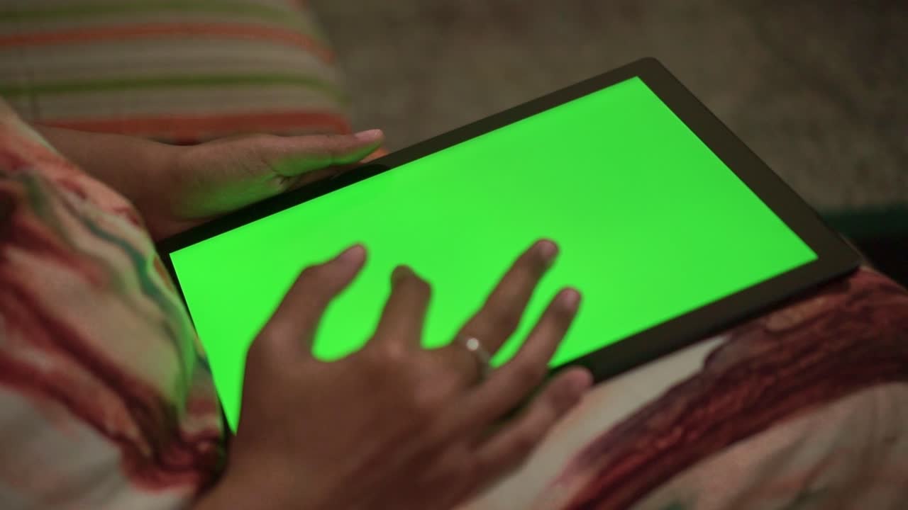 Hand interacting with tablet green screen. Digital device, touchscreen interface, and copy space for app or ads