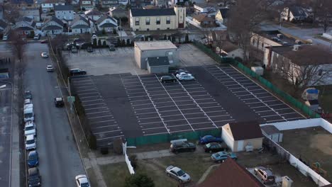 an aerial view of a car dealer storage lot at sunset