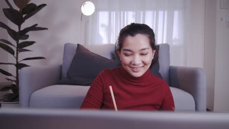 businesswoman on redshirt using the laptop for meeting online and work from home in coronavirus