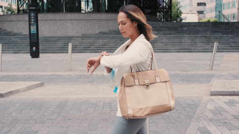 beautiful mixed race business woman walking through city