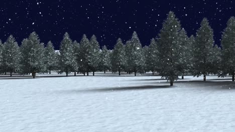 Snow-falling-over-multiple-tree-on-winter-landscape-against-black-background
