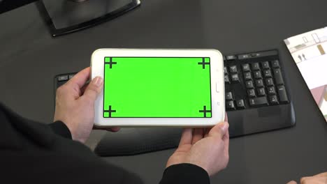 los dedos tocan la tableta, la computadora, el monitor de pantalla verde, la tableta digital.