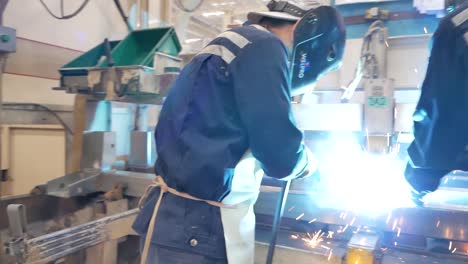 asian worker wear protection working in heavy metal factory, editorial