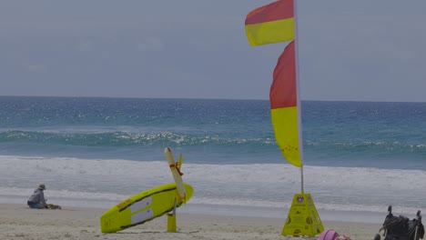 lifeguard flag and person on currumbin beach