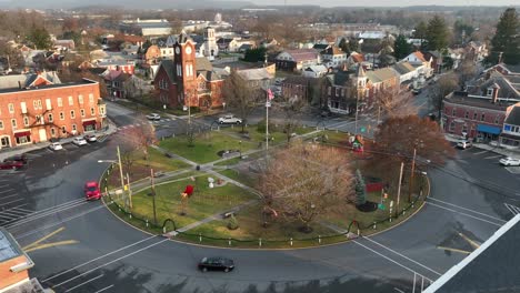 aerial establishing shot of american flag in center of roundabout