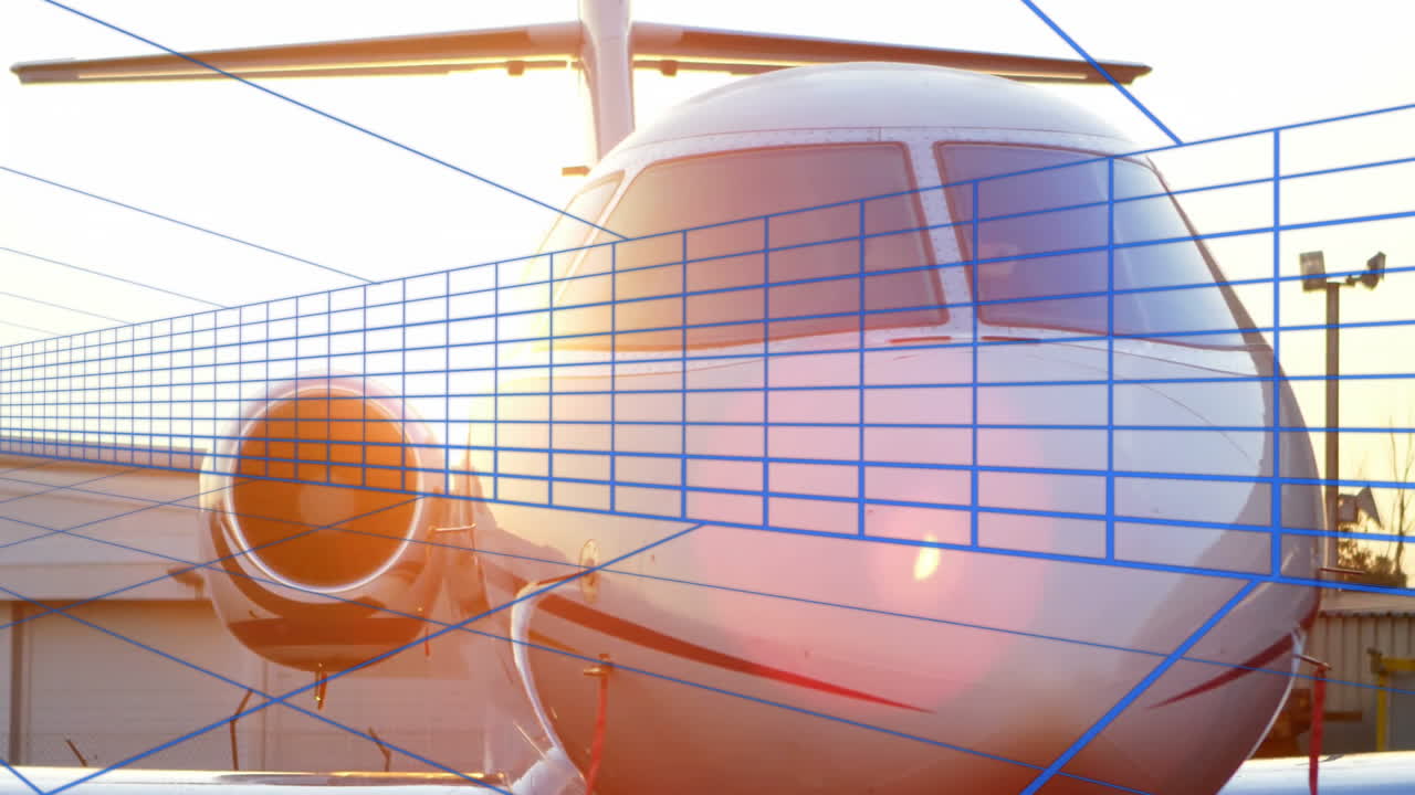 White private jet nose occupying apron featuring engine inlet and cockpit windows over blue grid