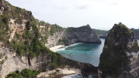 Wide-View-of-Diamond-Beach-Cove-and-Its-Jurassic-looking-high-Steep-cliffs-and-diamond-shaped-limestone-Rocks-from-Rumah-Pohon-Tree-house-and-Thousand-Islands-viewpoint-in-Nusa-Penida-Island---Bali