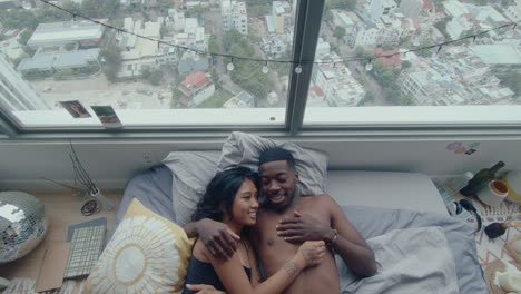 top down of loving couple chatting on bed after wake up