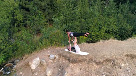 Two women practice acroyoga 4k