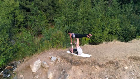 two women practice acroyoga 4k