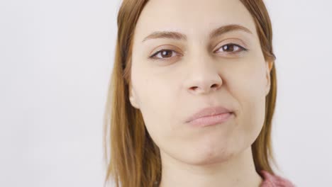 Woman-eating-chocolate-dragee-in-close-up.-Chocolate.