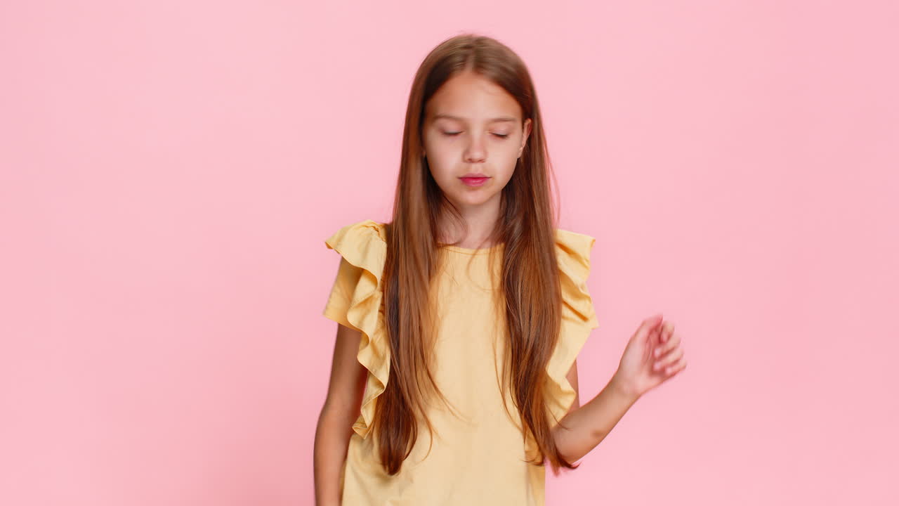 Child girl kid dancing with excitement showing rockandroll gesture with cool confident expression