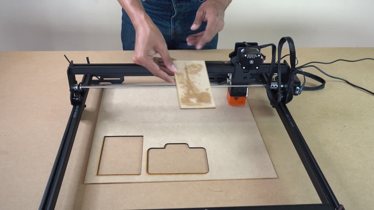 Man revealing laser-cut figures and clean edges