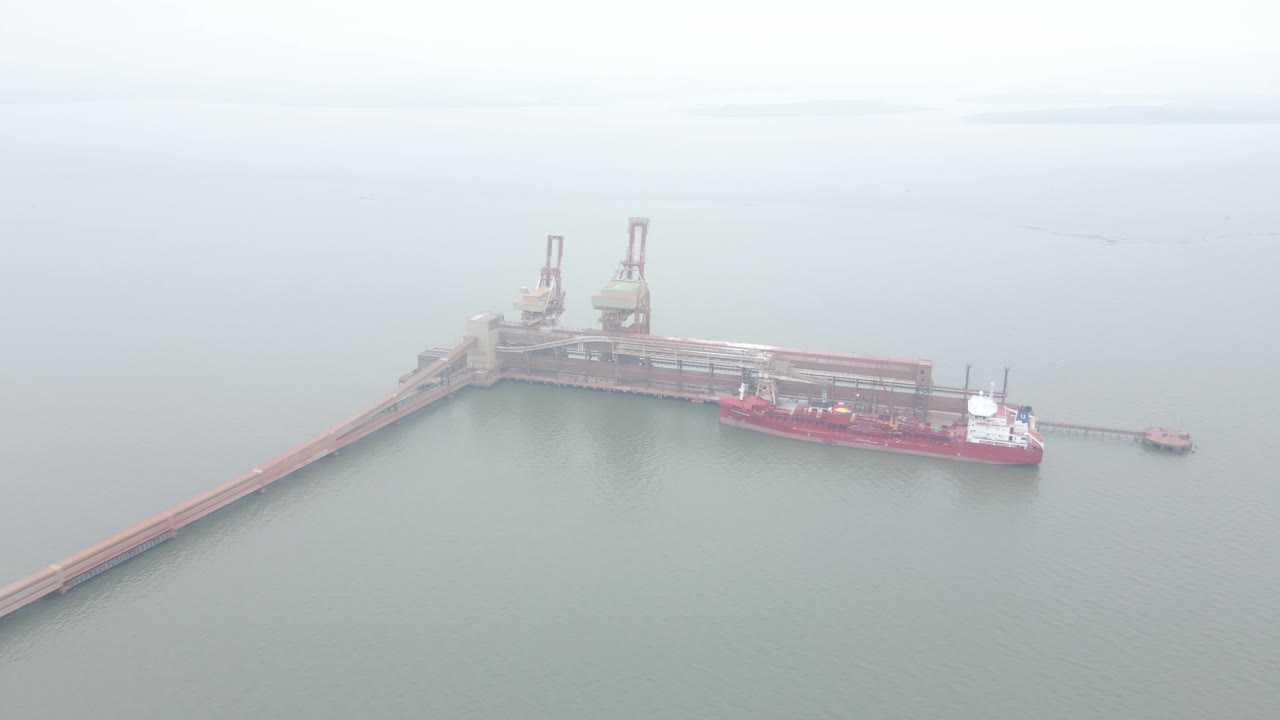 Cargo Ship at Port: Aerial View of Bulk Carrier Loading at a Dock