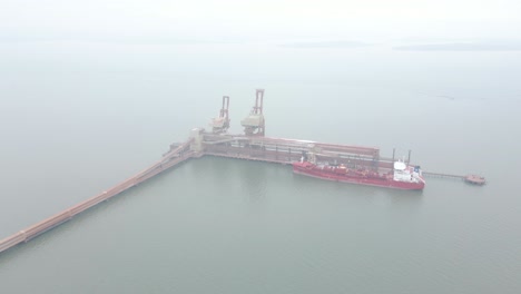 cargo ship at port: aerial view of bulk carrier loading at a dock