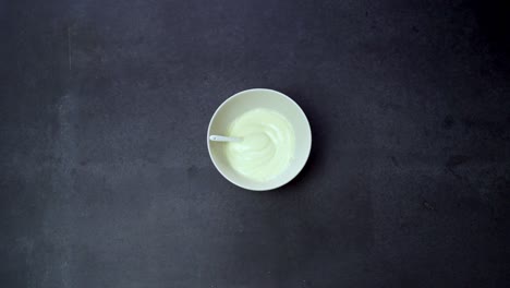 Hand-Grabs-Small-Bowl-Of-Mayonnaise.-overhead-shot