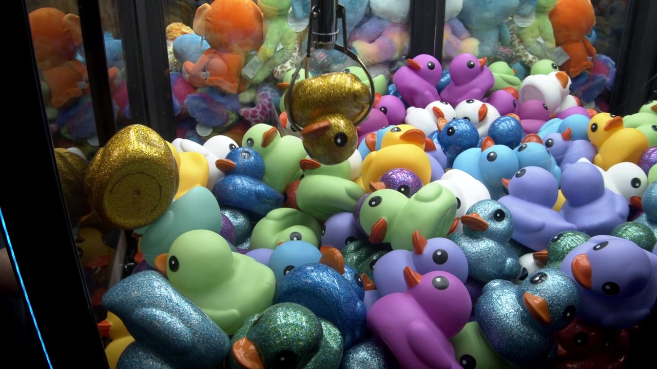 Arcade Claw Machine Winning A Rubber Duck Prize