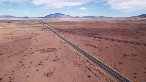 High-elevation-drone-view-of-a-highway-and-railroad-track-meeting