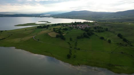 serene lakeside aerial view with rolling hills and farmland
