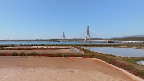 iconic arade river bridge spans the water as cars drive by, aerial orbit