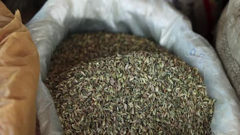 cumin seeds close up with black hand , organic fresh natural healthy food