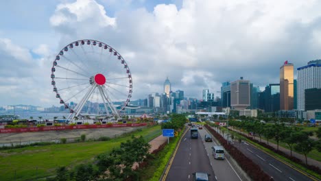 time lapse of the ferris wheel, hong kong observation wheel, and amusement park for kids in holiday vacation and travel trip concept. hong kong city. downtown and victoria harbour with blue sky.