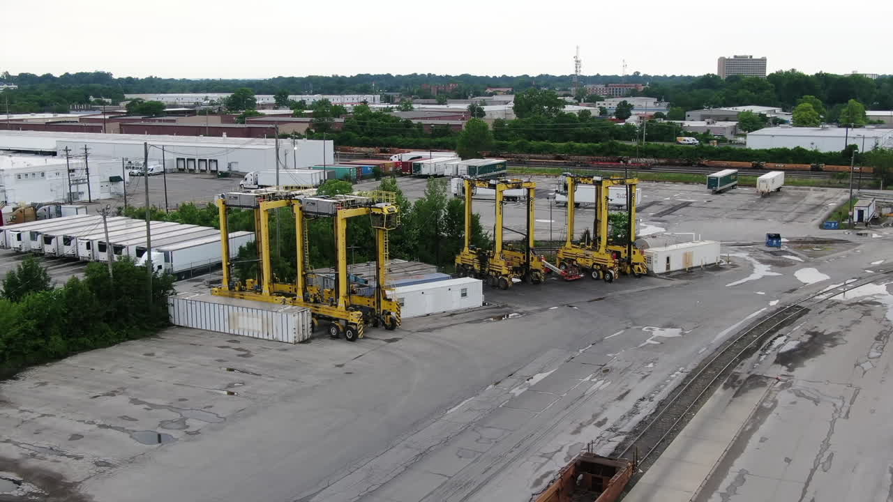 An aerial view of large cranes in a cargo train shipping yard in Jefferson County, Kentucky.