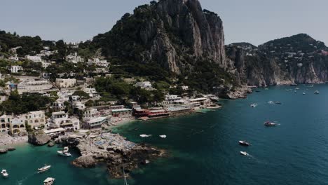 Rising-aerial-view-of-Capri,-Italy's-unique-coastline-at-midday