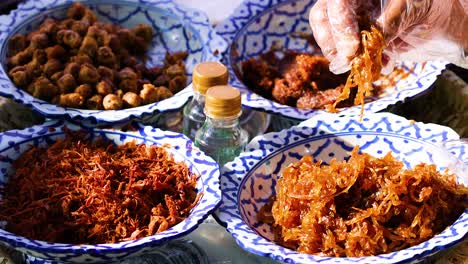 thai street food display with hand serving