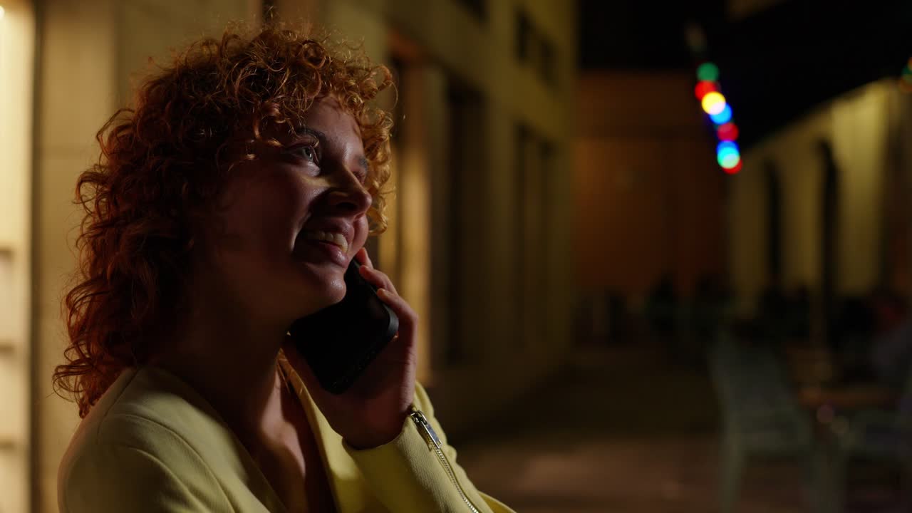 Woman talking on the phone at night